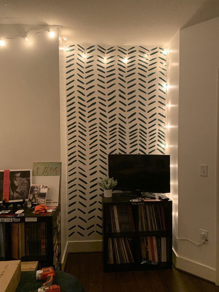 Hand painted chevron accent wall in a windowless room